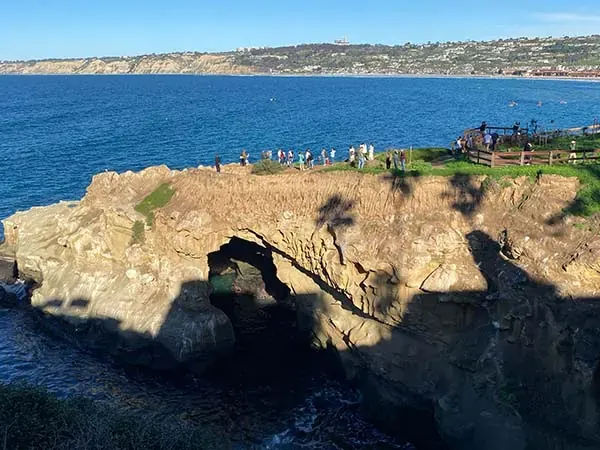 Clear water and rocky shoreline at La Jolla Cove on a bright coastal day